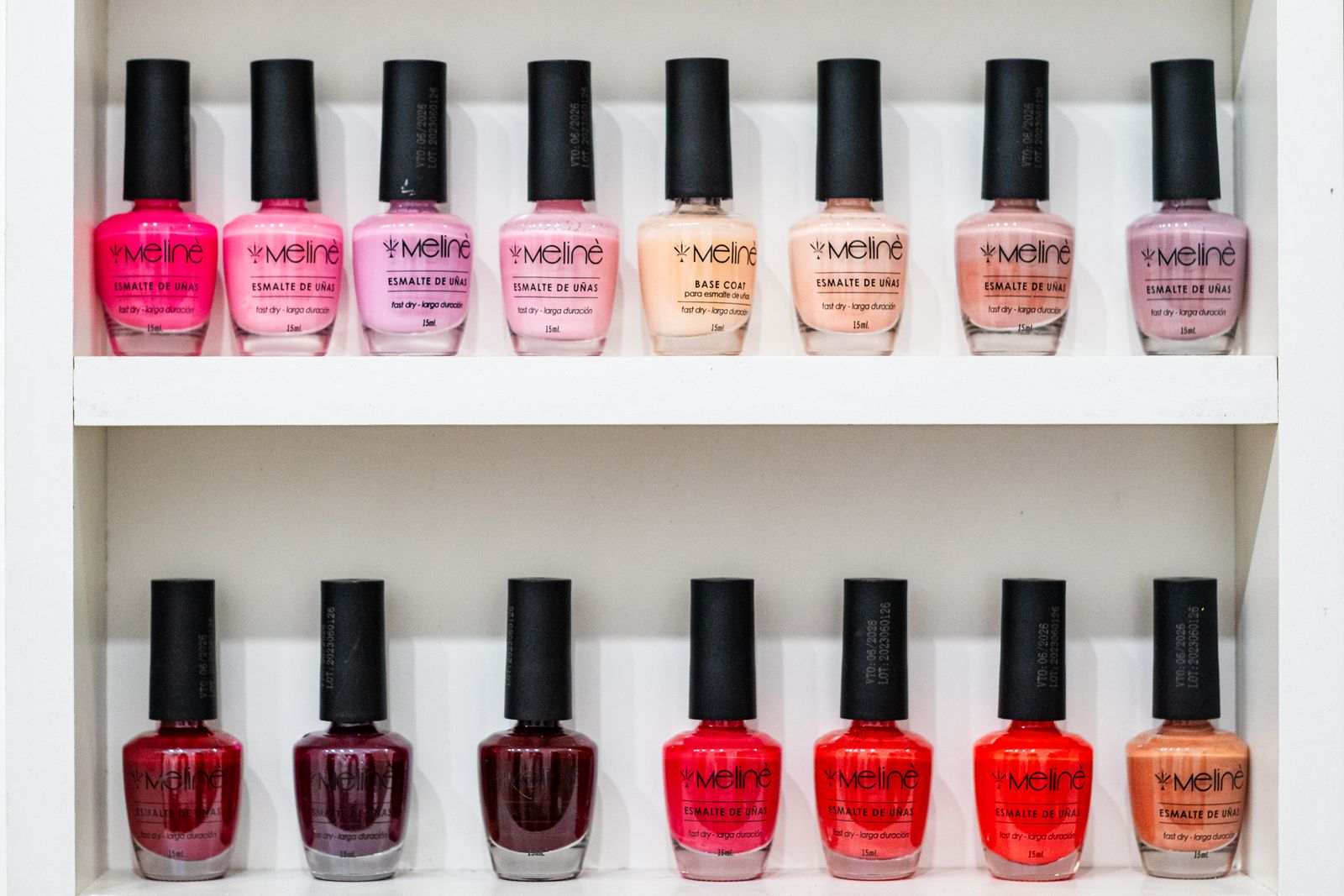 A row of colorful polish and color on the salon shelf