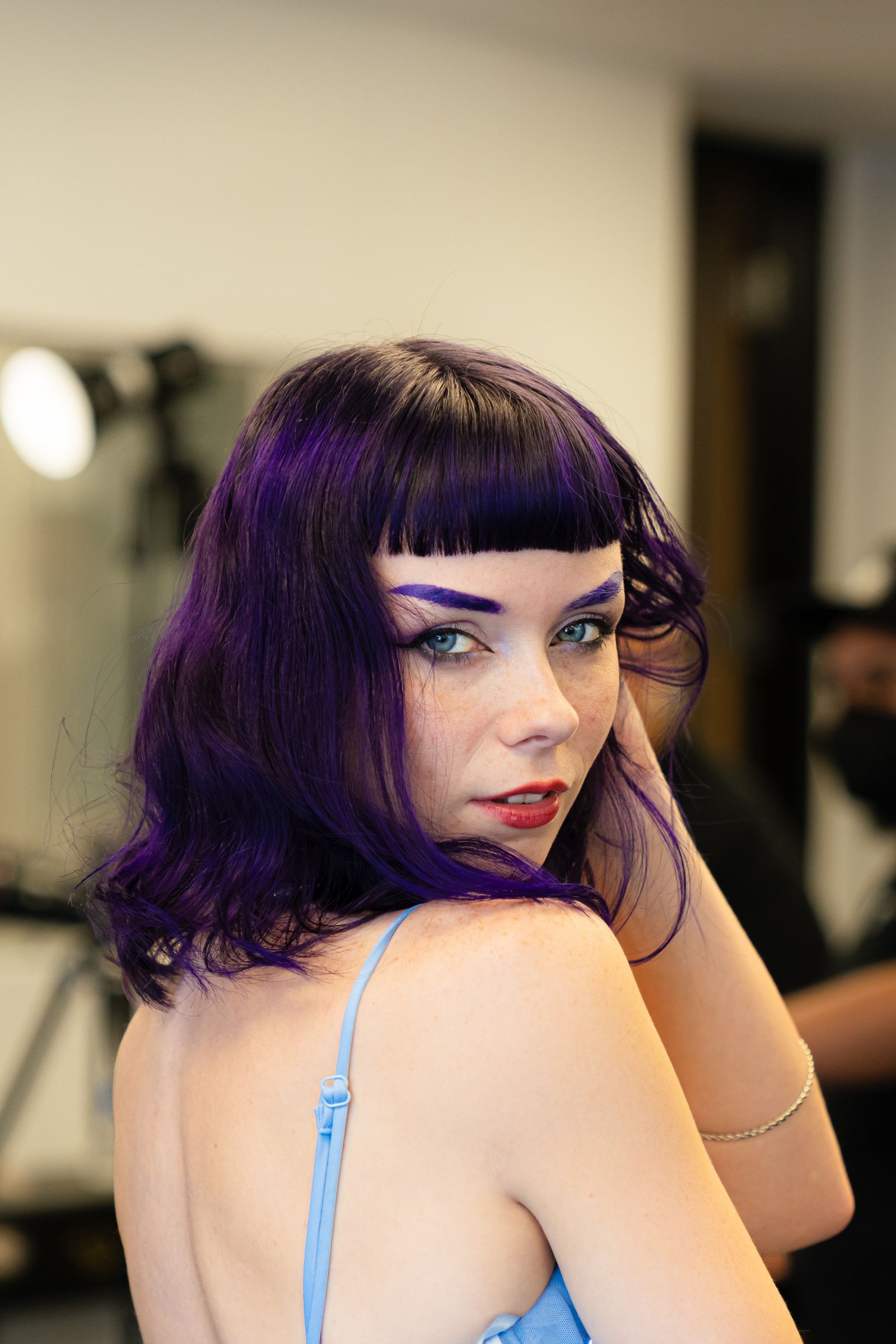 Client with vivid violet and magenta fashion-color hair